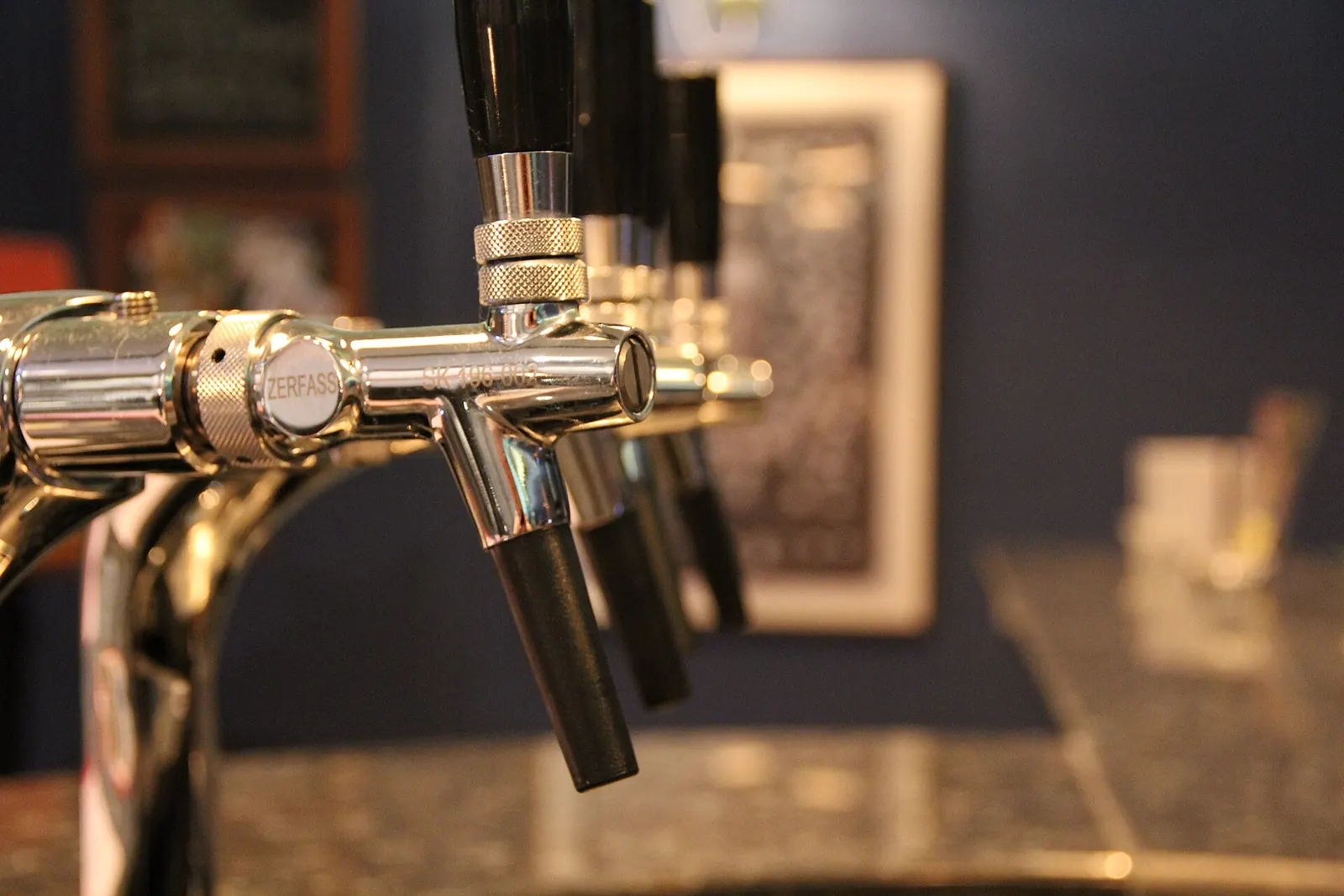 Chrome beer taps behind a bar